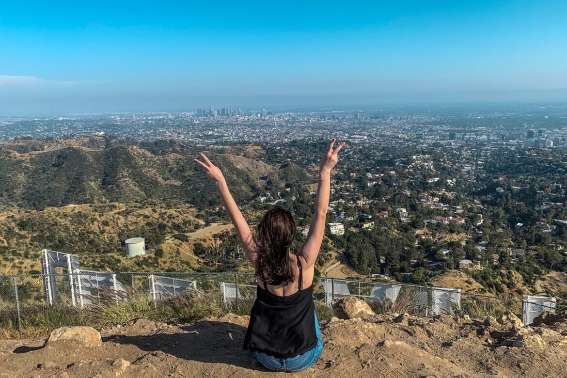 Traveler enjoying panoramic view of Los Angeles from a hilltop